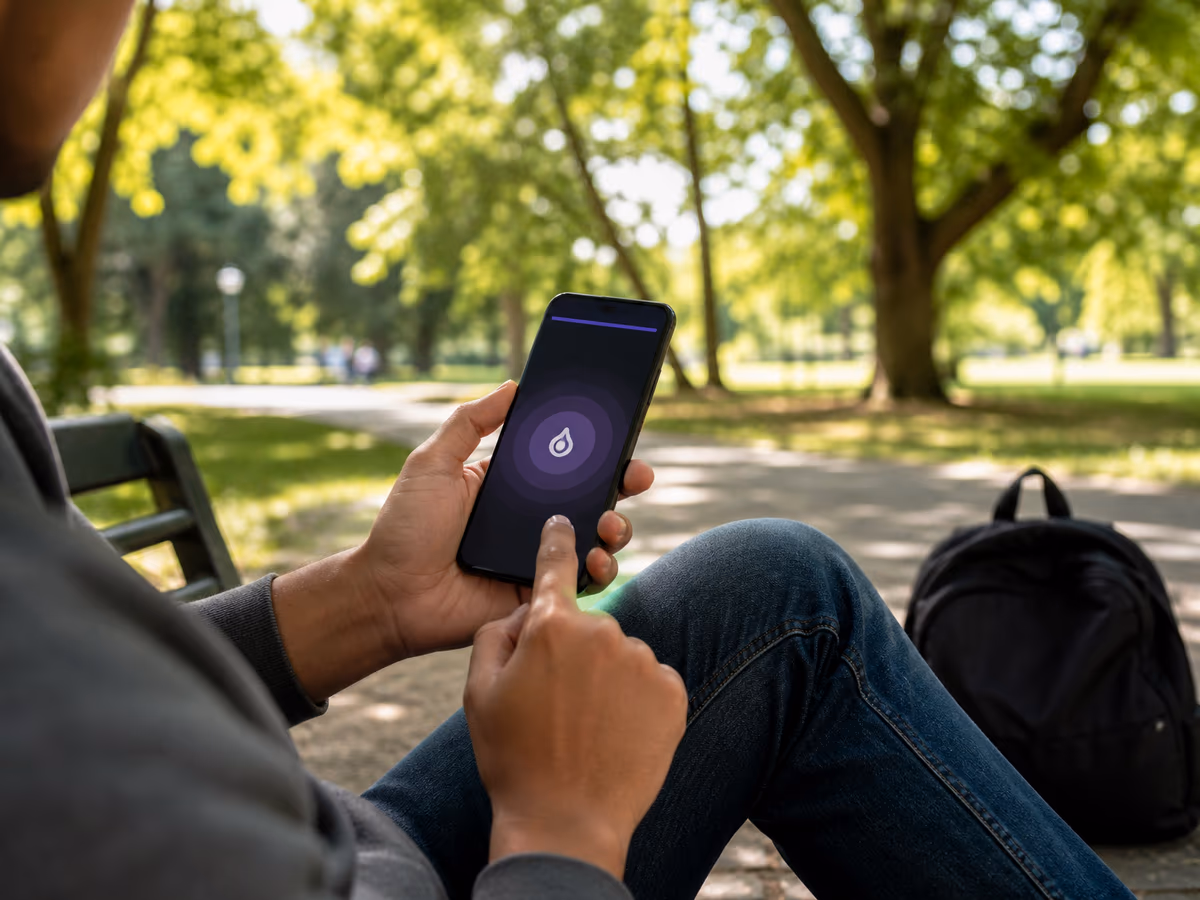A person using a smartphone to browse Tor links in a sunny park.